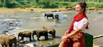 woman happily on tour in pinnawala elephant orphanage